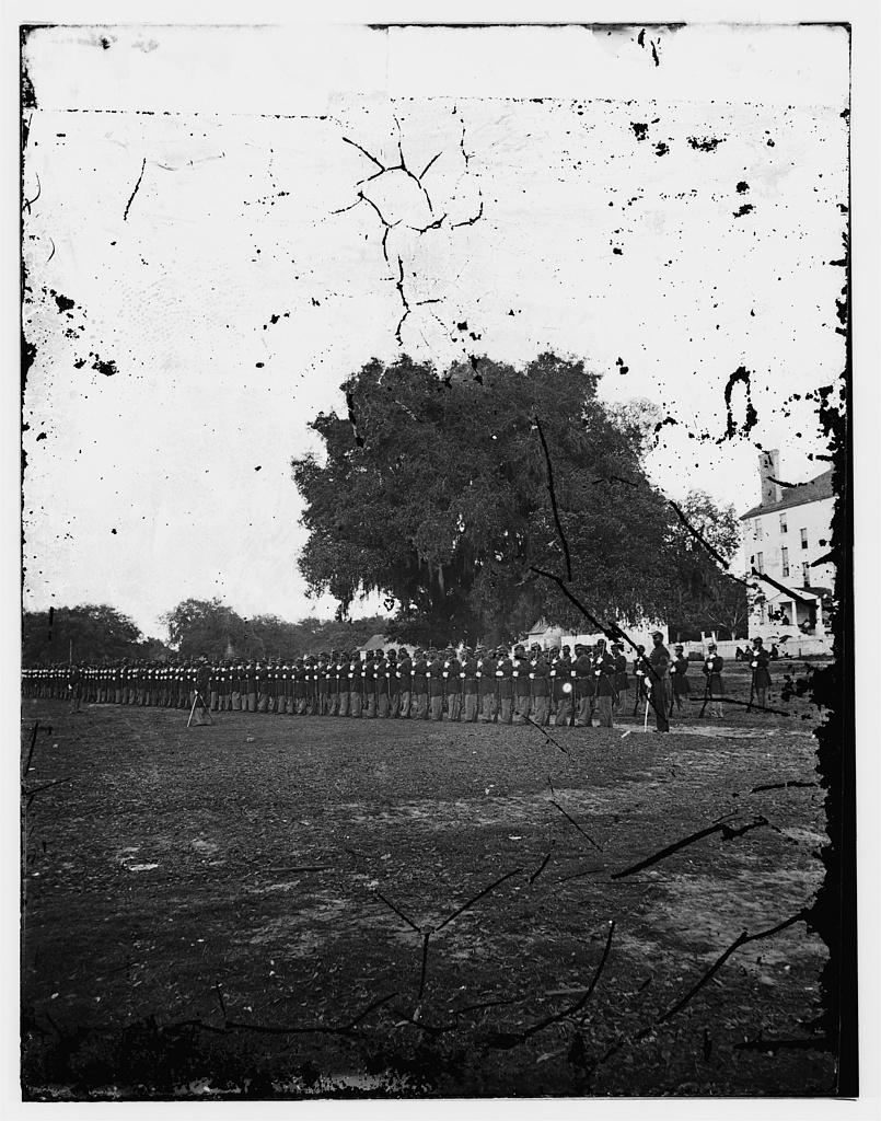 Archival photograph of the 29th Connecticut Regiment standing in formation at Beaufort, South Carolina, with visible damage to the original negative